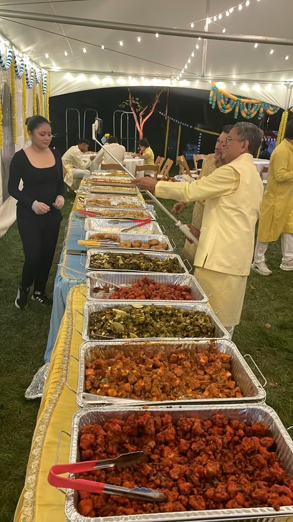 Catering staff serving guests from a buffet line